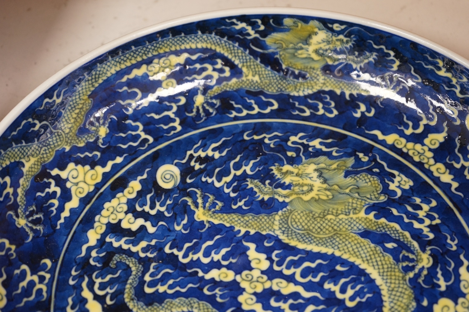 A Chinese blue and yellow glazed dragon dish, 33cm diameter., Condition - good